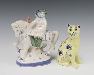 A Rye Pottery figure of a lady riding a horse 19cm together with an unmarked yellow glazed pottery figure of a Galle style cat with glass eyes 14cm 