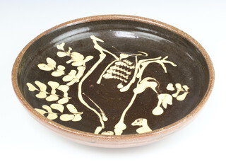 A slipware shallow bowl decorated with a stylised bird and impressed marks 26.5cm 