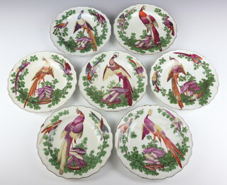 Seven Chelsea plates circa 1758-70 decorated exotic birds amongst foliage the central bird perched on rocks, all brown line rim and brown anchor mark, 21.5cm diameter 