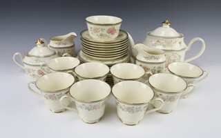 A Minton 33 piece Jasmine pattern tea service comprising teapot, lidded sugar bowl, sugar bowl, 2 cream jugs, 6 side plates, 6 tea plates, 8 cups and 8 saucers 