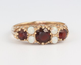 A Victorian style 9ct yellow gold garnet and opal ring, 2.4 grams, size O 1/2