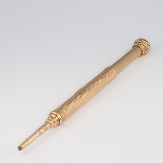 A yellow metal engraved 14kt engine turned propelling pencil, 14.5cm, gross weight 35.7 grams 