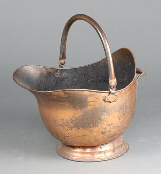 A copper helmet shaped coal scuttle with swing handle 25cm x 41cm x 30cm 