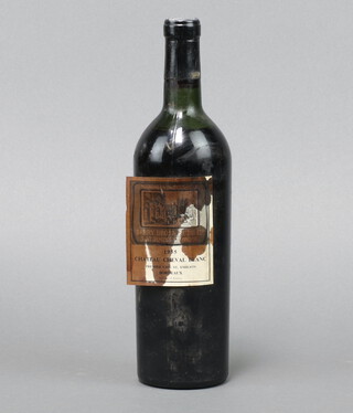 A bottle of 1955 Berry Brothers and Rudd Chateau Cheval Blanc, Premier Cru St Emilion, (label is damaged, wine is below the neck)  