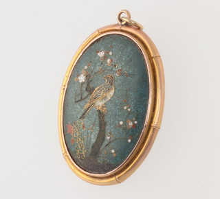 A yellow metal cloisonne pendant depicting a bird on a branch 35mm, gross weight 8 grams 