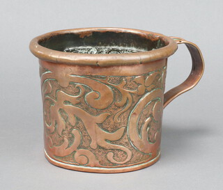 A Newlyn style circular embossed copper mug with freeform decoration 12cm x 14cm 