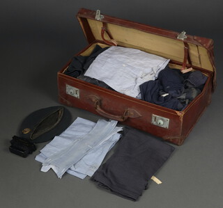 An RAF Aircraftman tunic size 7 1950, ditto trousers, great coat, battle dress blouse and trousers, 2 shirts, 3 collars, 2 pairs of socks, gloves, 2 shoe brushes, berry, cap badge and jumper, all contained in a leather suitcase 