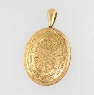 A Victorian engraved oval gilt locket 50mm