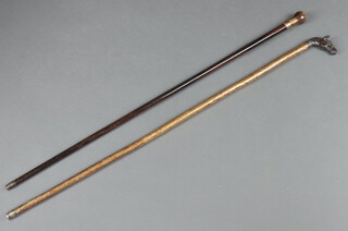 A lignum vitae walking cane with horn handle and a walking stick with metal horse head handle 