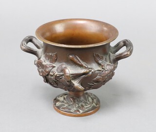 A 19th Century cast bronze twin handled urn with floral decoration 11cm h x 10cm diam. 