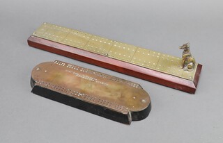 A 19th Century rectangular brass and ebonised wood cribbage board marked Colonel V Hatton Grenadier Guards 2cm x 25cm x 9cm and 1 other brass and mahogany cribbage board decorated a seated dog and with counter box (Colonel Villers Hatton CB 1852-1914) 