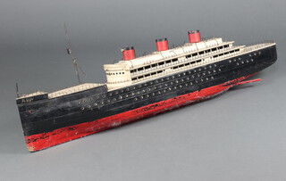 A scratch built model of "RMS Queen Mary" 48cm h x 132cm x 19cm d, the hull containing 6 lifeboats, the bow marked Robin    