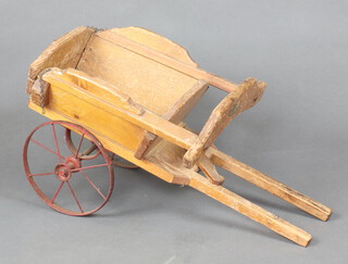 Swallow Toys, a child's pine tipping hand cart with metal wheels 27cm h x 54cm l x 25cm w, having label marked Swallow Toys, W&Co London N17  