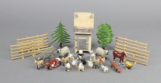 A collection of lead and cast metal toys to include a Taylor and Barrett stove, and 18 various Britains items including a panda, trees and fencing  