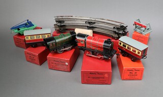 A collection of Hornby O gauge to include a red M1 locomotive 41010, no.20 crane truck 42134 in green and blue, no.21 coach 42117 x 2 in maroon, no.20 locomotive 41001 in racing green (dent to body), no.42300 and a box of half dozen curved rails A1 