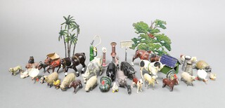 A collection of Britains lead and hollow cast figures mainly farm and domestic animals, together with 2 milk churns, dog kennel, 3 petrol pumps, wheelbarrow and trees  