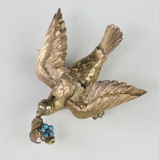 A gilt brooch in the form of a bird holding a flower set with turquoise stones 55mm 