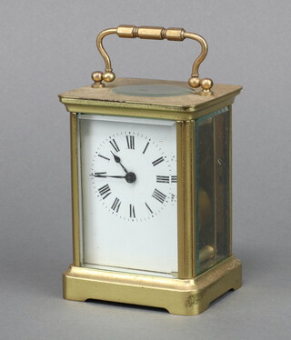 A 19th Century French 8 day carriage timepiece with 5cm enamelled dial, Roman numerals, contained in a gilt metal case marked R and C, Made in France 11cm x 7cm x 5.5cm, complete with key 