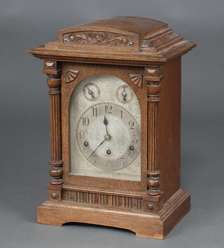 An early 20th Century German 8 day striking on gong bracket clock, the 17cm dial with Roman numerals, chime/silent dial, fast/slow dial, contained in an oak case 44cm h x 28.5cm w x 20cm d., complete with pendulum and key  