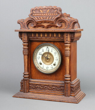 Ansonia, a 19th Century American 8 day, striking on gong, shelf clock with 11cm enamelled dial, Arabic numerals contained in a carved oak case 43cm h x 32cm w x 14cm d, complete with pendulum but no key 