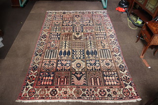 A white and blue ground floral patterned Afghan rug, the centre formed of 40 squares 303cm x 201cm  