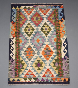 A white, green and black chobi kilim rug with all over geometric design, 123cm x 81cm 