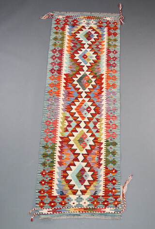 A white, orange and green ground Chobi Kilim runner with 6 diamonds to the centre 193cm x 63cm 