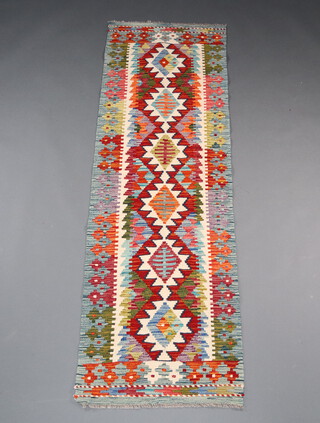 A white, orange and green ground Chobi Kilim runner with 6 diamonds to the centre 205cm x 65cm 