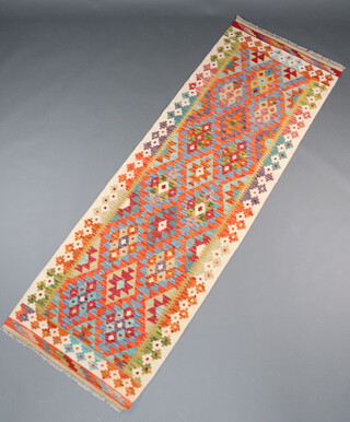 A yellow, turquoise and green ground Chobi Kilim runner with all over geometric designs 245cm x 80cm 