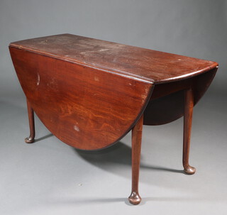 A Georgian mahogany oval drop flap dining table raised on club supports with pad feet 72cm h x 139cm x 53cm 