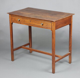 An 18th Century oak side table, the top formed of 3 planks fitted a drawer, raised on square turned supports with H framed stretcher 74cm h x 92cm w x 50cm d  