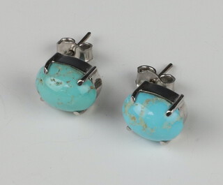 A pair of white metal turquoise ear studs 