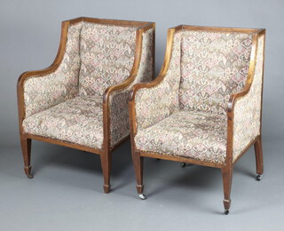 A pair of Edwardian mahogany show frame wing armchairs upholstered in tapestry material, raised on square supports 89cm h x 56cm w x 41cm d (seat 40cm x 42cm) 