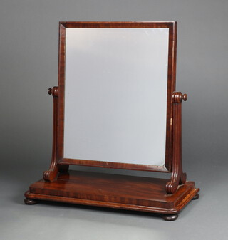 A Victorian rectangular plate dressing table mirror contained in a mahogany swing frame, raised on bun feet 80cm x 71cm x 32cm  