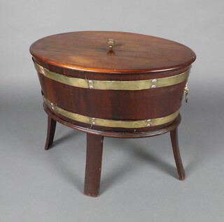 A 19th Century oval mahogany cellarette with gilt metal banding and lion ring drop handles, raised on outswept supports 53cm h x 61cm w x 44cm d 