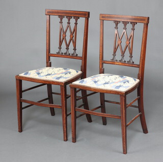 A pair of Edwardian inlaid mahogany bedroom chairs with tracery backs and upholstered seats raised on square tapered supports 85cm h x 42cm w x 38cm d 