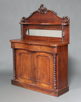 A Victorian mahogany chiffonier of serpentine outline, the raised back with shelf above mirror, the base fitted a secret drawer above pair of panelled doors with spiral turned columns to the sides, on a platform base 148cm h x 105cm w x 38cm d 