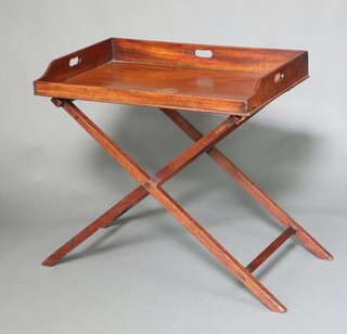 A rectangular mahogany butler's tray raised on a folding stand 76cm h x 82cm w x 54cm d 