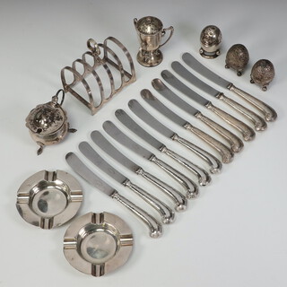 A pair of silver ashtrays Birmingham 1925, a silver toast rack, mustard, trophy cup, 3 silver peppers and 11 silver handled pistol grip butter knives, weighable silver 336 grams 