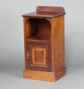 An Edwardian inlaid mahogany bedside cabinet with raised back above recess and panelled door, on a platform base 83cm h x 41cm w x 36cm d 