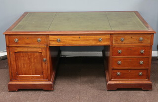 A Victorian mahogany partners desk with green inset writing surface, the top fitted 2 long and 2 short drawers, the sides fitted 2 chart drawers, the pedestals fitted 6 short drawers and cupboards 80cm h x 182cm w x 120cm c 