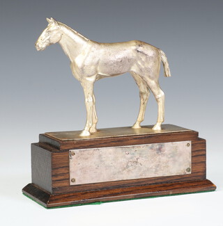 A silver plated model of a standing race horse, raised on a wooden plinth, 14cm 