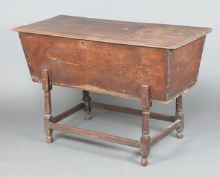 An 18th Century elm dough bin with hinged lid, interior fitted 2 sections, raised on turned and block supports 83cm h x 129cm w x 57cm d 