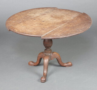 An 18th Century circular oak tea table on turned column and tripod base 49cm h x 76cm diam. 