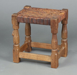 Robert Thompson (Mouseman), a rectangular oak stool with woven leather seat, raised on turned and block supports 36cm h x 33cm w x 26cm 