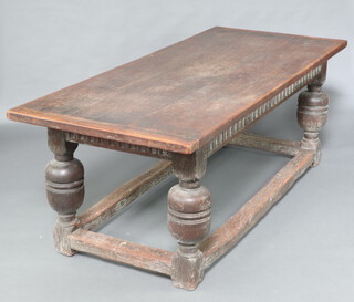 A 17th Century oak refectory table with arcaded decoration, raised on cup and cover supports with later plank top 77cm h x 213cm l x 92cm w 