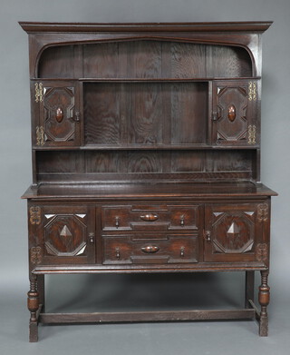 A reproduction 18th Century Jacobean style oak dresser, the raised back fitted shelves flanked by pair of cupboards the base fitted 2 long drawers flanked by cupboards, raised on cup and cover supports 192cm h x 152cm w x 54cm d 