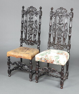 A pair of Victorian Carolean style pierced and ebonised high back chairs with overstuffed seats, raised on turned and block supports 125cm h x 49cm w x 40cm d 