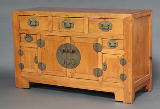 A 19th Century Chinese light hardwood sideboard fitted 3 long drawers above 2 short drawers above triple cupboard, having gilt metal drop handles 93cm h x 151cm w x 58cm d 