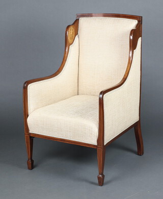 An Edwardian inlaid mahogany show frame wing armchair upholstered in light coloured material raised on square tapered supports, spade feet 97cm h x 58cm w x 62cm d  